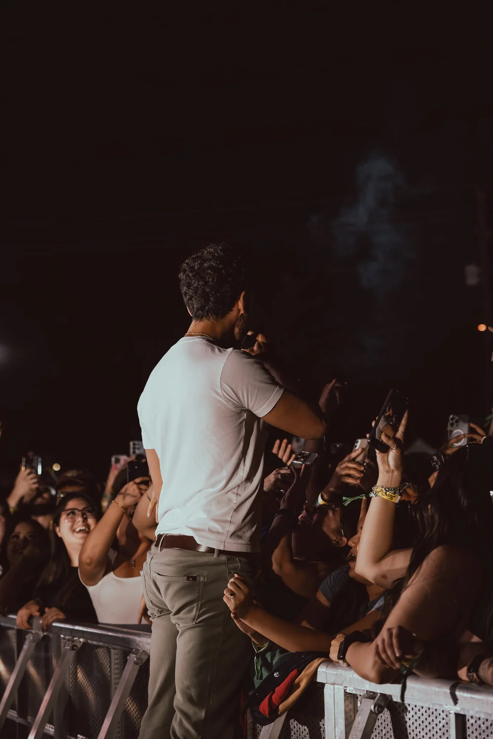 Front row laughing at the barricade during a late set